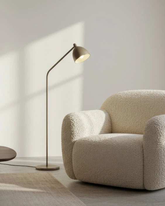 Beige armchair and floor lamp in a minimalistic room with soft lighting